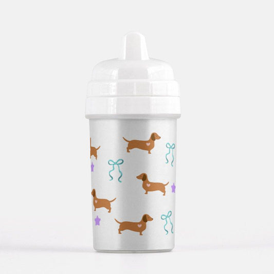 White sippy cup with dachshund pattern on a white background